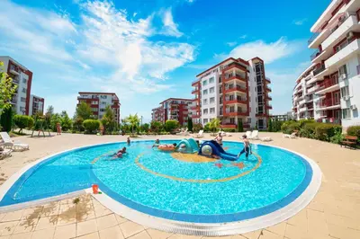 a large swimming pool with people playing in it at Double Peach Apartment in Sveti Vlas