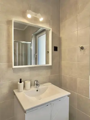 a bathroom with a sink and a mirror at Carina Beach - Private apartment - BSR - 1 in Sunny Beach