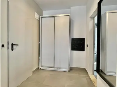 a sliding door in a hallway with a sign on the wall at Carina Beach - Private apartment - BSR - 1 in Sunny Beach