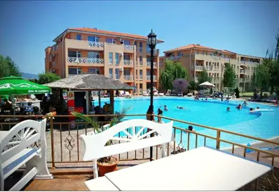 a large swimming pool with people swimming in it at Double Cherry Apartment in Sunny Beach