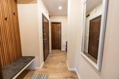 a hallway with a bench and a door at Apartment Maria in Burgas City