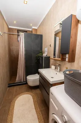 a bathroom with a toilet and a sink and a shower at Apartment Maria in Burgas City