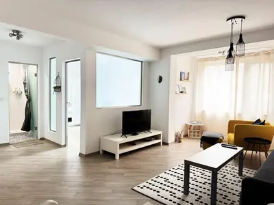 a living room with a tv and a couch at Urban Oasis in Varna City