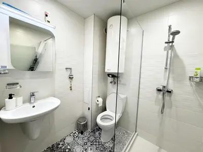 a bathroom with a toilet and a sink and a shower at Urban Oasis in Varna City