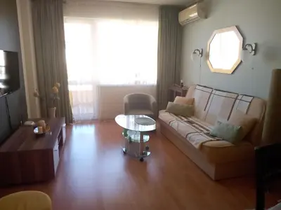 a living room with a couch and a table at Splendid sunny seasons in Byala