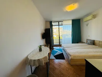 a room with two beds and a table in it at SAINT ELENA APART COMPLEX 47 Studio in Sunny Beach
