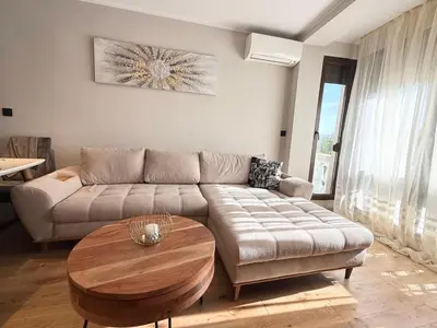 a living room with a couch and a coffee table at Sea Garden luxury appartments in Varna City