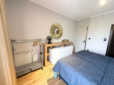 a bedroom with a bed and a mirror on the wall at Sea Garden luxury appartments in Varna City