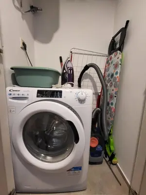 a washing machine in a corner of a room at Sea Garden luxury appartments in Varna City