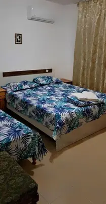 a bedroom with two twin beds and a window at Family House Victoria' Garden in Primorsko