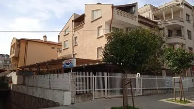 a white fence in front of a building at Апартамент в непосредствена близост до плажа III in Burgas City