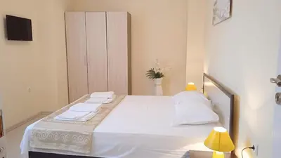a bedroom with a bed with white sheets and pillows at Апартамент в непосредствена близост до плажа III in Burgas City
