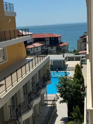 a view of the pool from the balcony of a building at Grand Villa Perle in Sveti Vlas