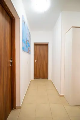 a hallway with a door and a tile floor at Spacious 2BD Apartment - Walk to City Center and free Parking by Flat Mаnager in Burgas City
