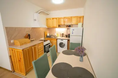 a kitchen with a table and a dining room at Spacious 2BD Apartment - Walk to City Center and free Parking by Flat Mаnager in Burgas City