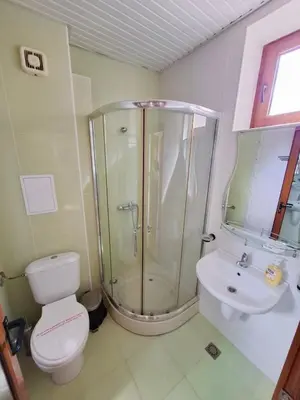 a bathroom with a shower and a toilet and a sink at Stamopolu Apartments in Primorsko