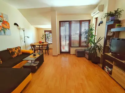 a living room with a couch and a tv at Апартамент Цар Самуил in Burgas City