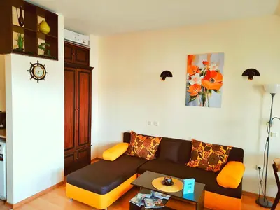 a living room with a couch and a table at Апартамент Цар Самуил in Burgas City
