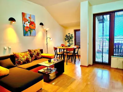 a living room with a couch and a table at Апартамент Цар Самуил in Burgas City