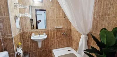 a bathroom with a sink and a toilet and a mirror at Apartment in complex Sirena! in Sveti Vlas