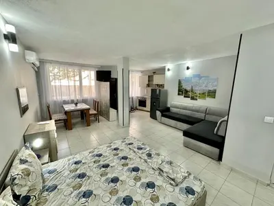 a living room with a bed and a couch at Студио Боряна in Pomorie