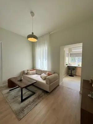 a living room with a couch and a table at Heart of Varna, Close to the Sea in Varna City