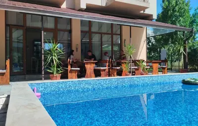 a pool in front of a hotel with a restaurant at Hotel 415 in Sunny Beach