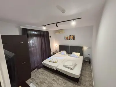 a bedroom with a bed with two white towels on it at Hotel 415 in Sunny Beach