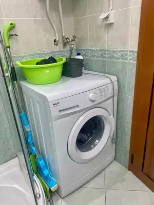 a washing machine with a green bowl on top of it at Studio Blue Triumph in Sveti Vlas