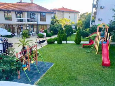 a yard with a playground with a slide at Studio Blue Triumph in Sveti Vlas