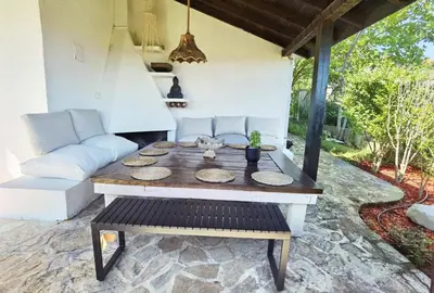 a table and a couch on a patio at Вила Алба in Lozenets