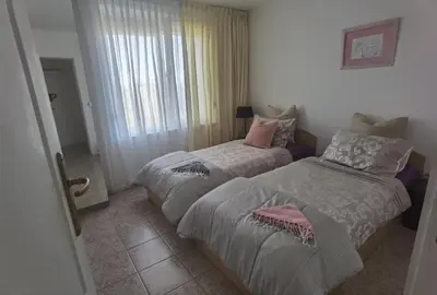 a bedroom with two beds and a window at Вила Алба in Lozenets