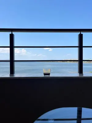 a view of the ocean from a window with a bowl at Lago Mare Apartment in Pomorie