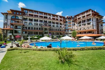 a hotel with a pool in front of a building at Apartment in the complex Olymp in Sveti Vlas
