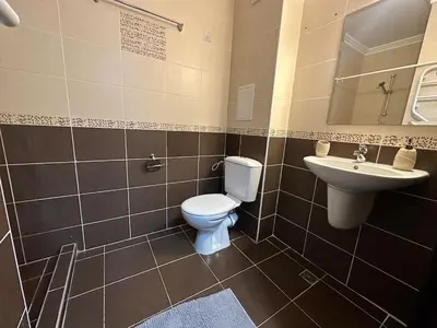 a bathroom with a toilet and a sink at Apartment in the complex Olymp in Sveti Vlas