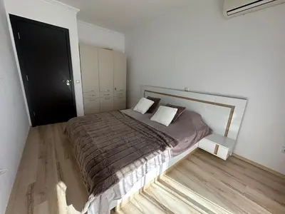 a bedroom with a large bed in a room at Apartment in the complex Olymp in Sveti Vlas