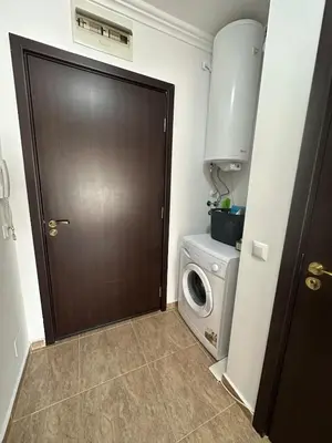 a door to a laundry room with a washing machine at Apartment in the complex Olymp in Sveti Vlas