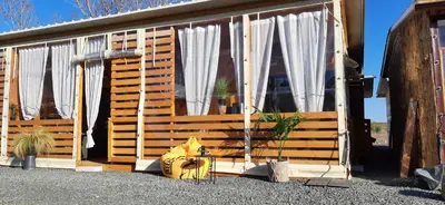 a yellow fire hydrant in front of a cabin at Бунгало Шангри Ла-3, плаж Градина in Sozopol