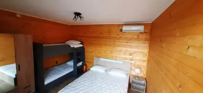 a small room with two bunk beds in it at Бунгало Шангри Ла-3, плаж Градина in Sozopol