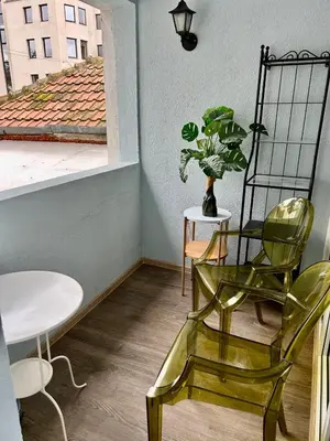 a room with a chair and a table and a plant at Family in Varna City