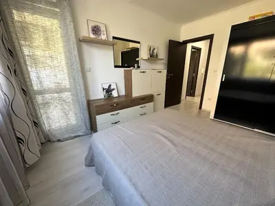 a bedroom with a bed and a flat screen tv at Apartment in Sveti Vlas in Sveti Vlas