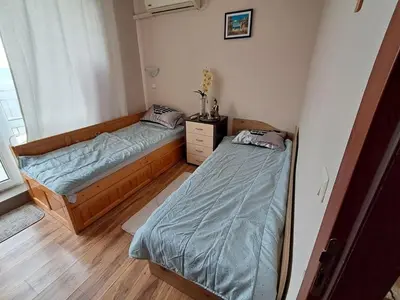 a bedroom with two beds and a window at Apartament in Aheloy in Aheloy