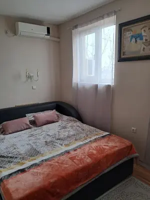 a bed in a bedroom with a window at Apartament in Aheloy in Aheloy