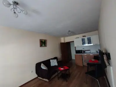 a living room with a couch and a kitchen at Studio Zora in Burgas City