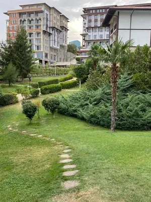 a row of christmas trees in a park with buildings at Etara 2 Apartment in Sveti Vlas