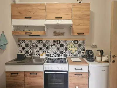 a small kitchen with a stove and a sink at Релакс в Равда! in Ravda