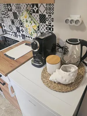 a kitchen counter with a toaster and other kitchen items at Релакс в Равда! in Ravda