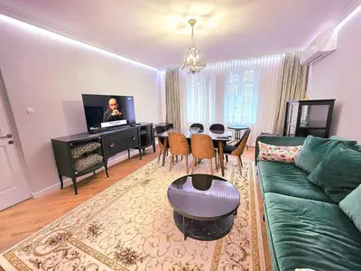 a living room with a green couch and a table at Seaside Apartment in Varna City