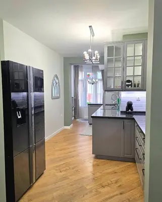 a kitchen with a refrigerator and a counter top at Seaside Apartment in Varna City