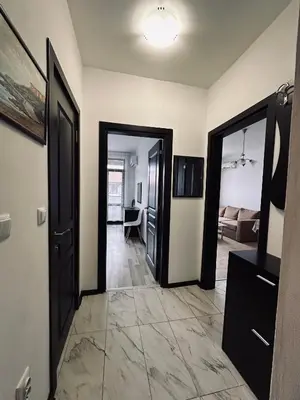 a hallway with two doors and a living room at Green apartments in Primorsko